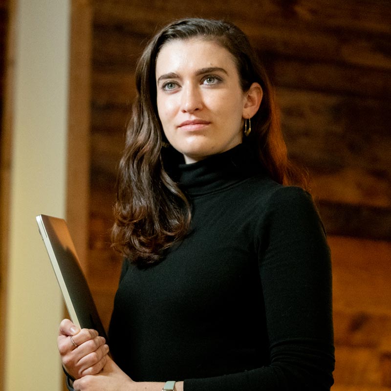 a student holds a laptop